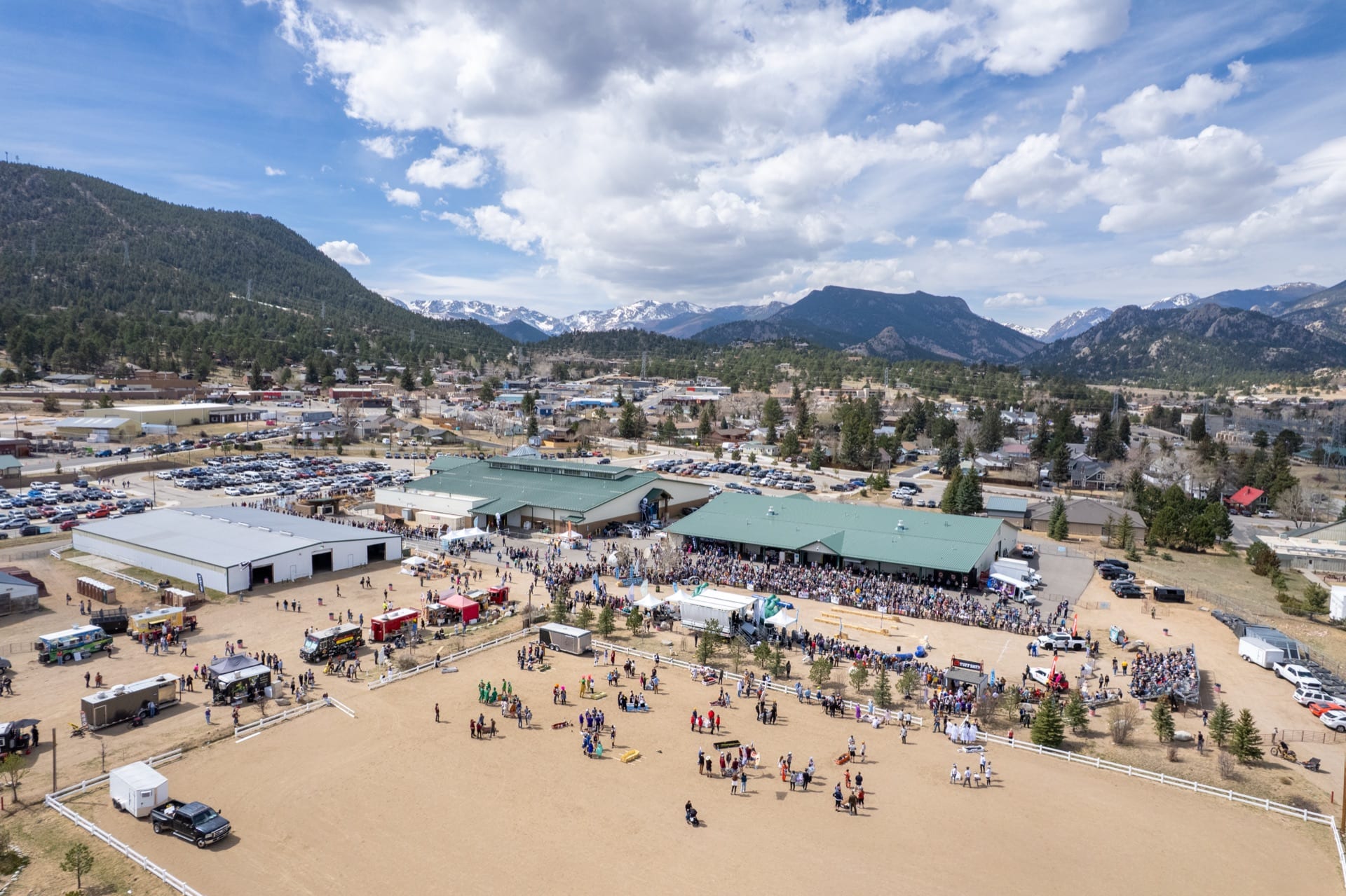 Aerial view of the Estes Park Events Complex and town with mountains beyond.
