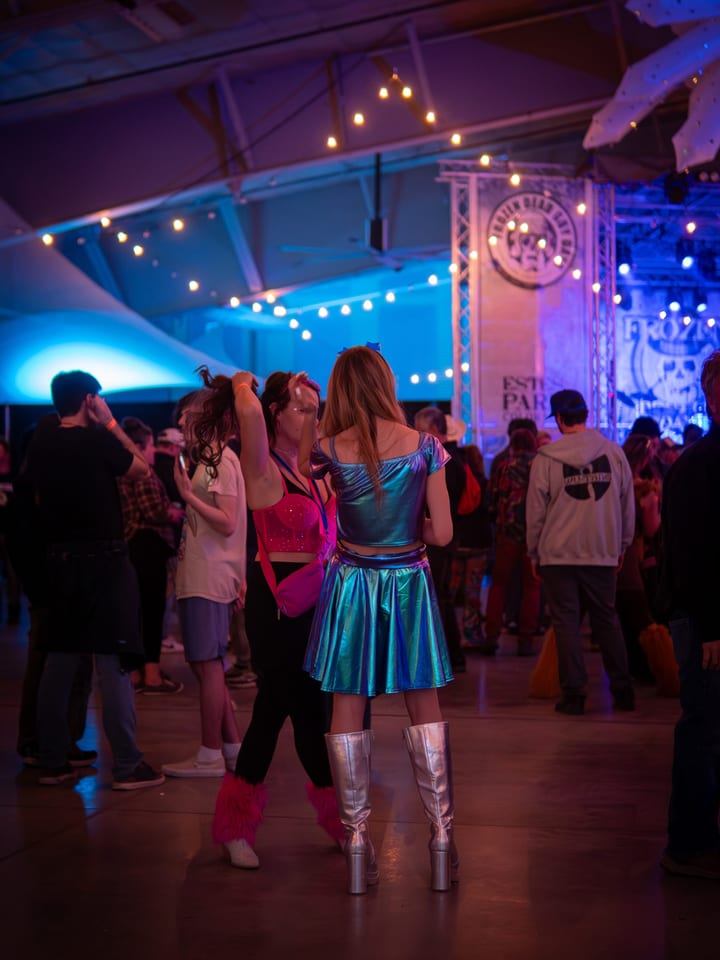 Dancers in silver go-go boots and metallic skirts by the Ice Room stage.