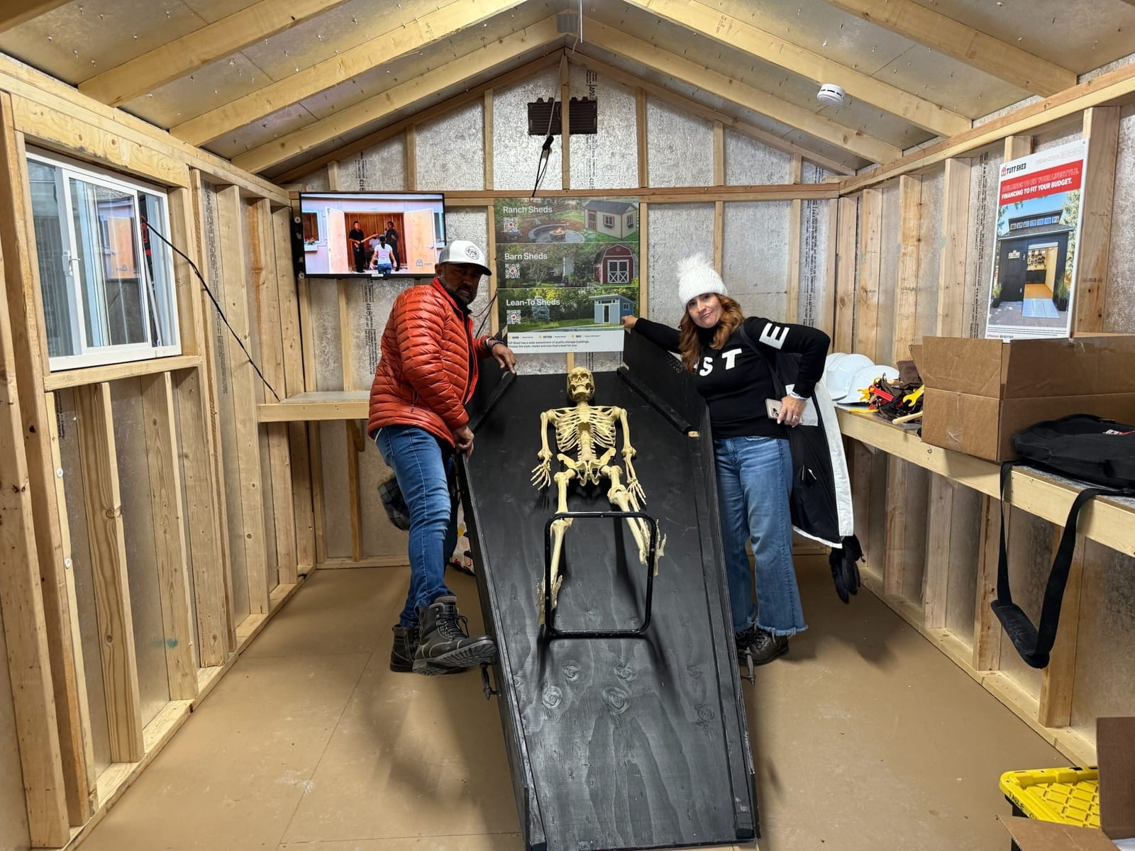 Visitors look inside a Tuff Shed shed with a skeleton laid out on a table.